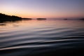 Midnight sea Sun in Northern Sweden during light Summer nights. Mirror like water surface, rose blue pink sky colored by Sun just Royalty Free Stock Photo