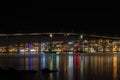 Midnight view of Tromso with colorful city lights and reflection in the sea, Norway Royalty Free Stock Photo
