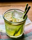 Midori Sour Cocktail with ice and lemon.