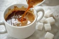 midpour closeup coffee with sugar cubes ready on the side Royalty Free Stock Photo
