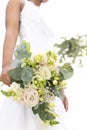 Midsection of african american bride holding bouquet standing in sunny garden Royalty Free Stock Photo