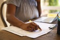 Midsection of african american woman working in living room using laptop and making notes Royalty Free Stock Photo