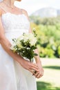 Midsection of bride holding bouquet in garden Royalty Free Stock Photo