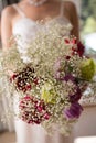 Midsection of bride holding bouquet at home Royalty Free Stock Photo