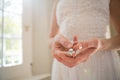 Midsection of bride holding diamond earring at home Royalty Free Stock Photo