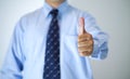 Midsection of business men show thumb up