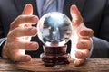 Midsection Of Businessman Covering Crystal Ball