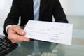Midsection of businessman giving cheque Royalty Free Stock Photo