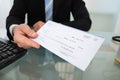 Midsection of businessman giving cheque Royalty Free Stock Photo