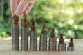 Midsection of businessman placing chess pieces on stacked coins