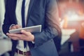 Midsection of businessman using digital tablet in office