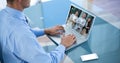 Midsection of businessman video conferencing with partners on laptop Royalty Free Stock Photo