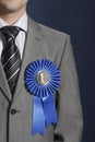 Midsection Of Businessman Wearing Blue Ribbon On Lapel