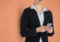 Midsection of businesswoman holding smart phone