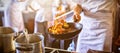 Midsection of chef cooking in kitchen stove Royalty Free Stock Photo