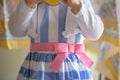 Little girl wearing Easter dress holding juice glass