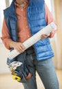 Midsection Of Construction Worker Holding Blueprint Royalty Free Stock Photo