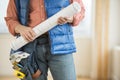 Midsection Of Construction Worker Holding Blueprint Royalty Free Stock Photo