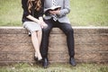 Midsection of a couple sitting on blocks and lovingly reading a book Royalty Free Stock Photo