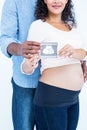 Midsection of couple with sonogram Royalty Free Stock Photo