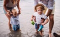 A midsection of family with two toddler children outdoors by the river in summer. Royalty Free Stock Photo