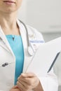 Midsection of female doctor with clipboard at clinic Royalty Free Stock Photo