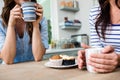 Midsection of female friends holding coffee mugs Royalty Free Stock Photo