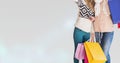 Midsection of female friends with shopping bags standing against white background Royalty Free Stock Photo