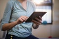 Midsection of female therapist using digital tablet
