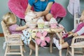 Midsection of girl pretending to have tea party with her dolls