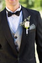 Midsection of groom wearing boutonniere