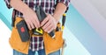 Midsection of handy man holding drill on blue and white stripes Royalty Free Stock Photo