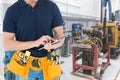 Midsection of handyman using tablet PC at workshop Royalty Free Stock Photo