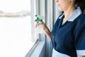 Maid Cleaning Window In Hotel Room Royalty Free Stock Photo