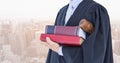 Midsection of judge with books and gavel against city Royalty Free Stock Photo