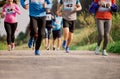 Midsection of large group of people running a race competition in nature. Royalty Free Stock Photo