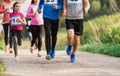 Midsection of large group of people running a race competition in nature. Royalty Free Stock Photo