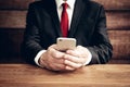 Midsection of a male businessman wearing a suit and using a mobile phone Royalty Free Stock Photo