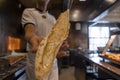 Close-up of chef holding freshly baked Turkish cheese pide at restaurant Royalty Free Stock Photo