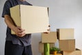 Midsection of man carrying open cardboard box in new home Royalty Free Stock Photo