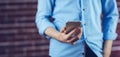 Midsection of man holding cellphone Royalty Free Stock Photo