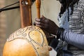 Midsection of man playing kora lute