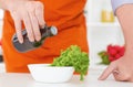 Mid section of mature man pouring olive oil over fresh salad in restaurant kitchen. Royalty Free Stock Photo