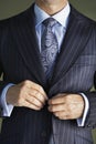 Midsection Of Man In Suit Buttoning Button On Coat
