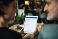 Midsection of man and woman having business meeting in a cafe, using tablet. Royalty Free Stock Photo