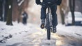 Midsection of mountain biker riding in snow outdoors in winter.