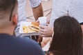 Midsection of people eating fast food outdoor takeaway