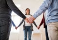 Midsection of people standing in a circle and holding hands during group therapy. Royalty Free Stock Photo