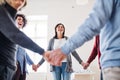 Midsection of people standing in a circle and holding hands during group therapy. Royalty Free Stock Photo