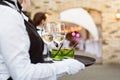 Midsection of professional waiters in uniform serving wine, cocktails and snacks during buffet catering party, festive Royalty Free Stock Photo